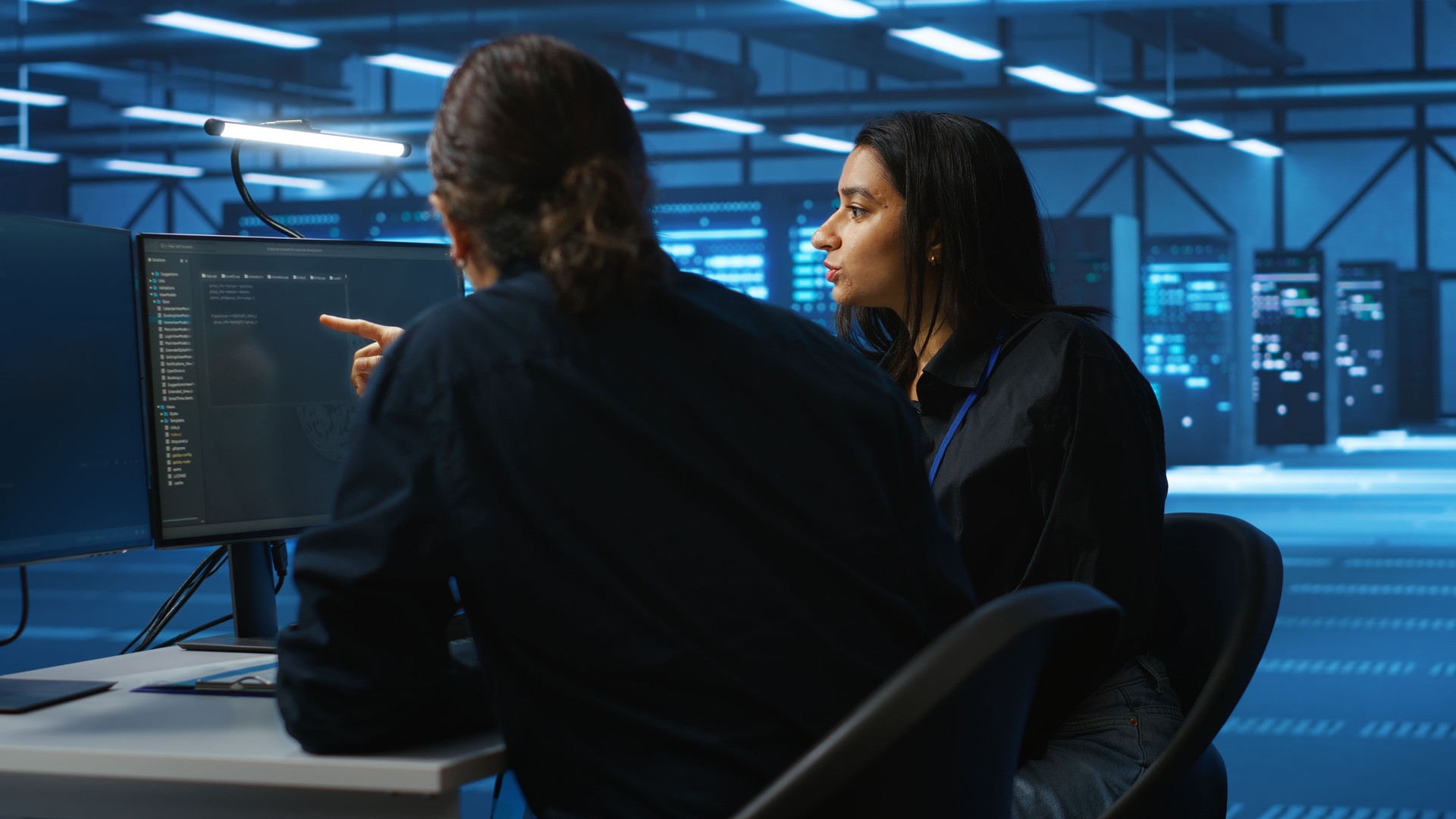 Multiethnic colleagues overseeing supercomputers in data center